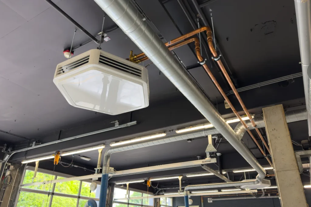 Fancoil-unit met aanvoer via geïsoleerde luchtkanalen en koperen leidingen.